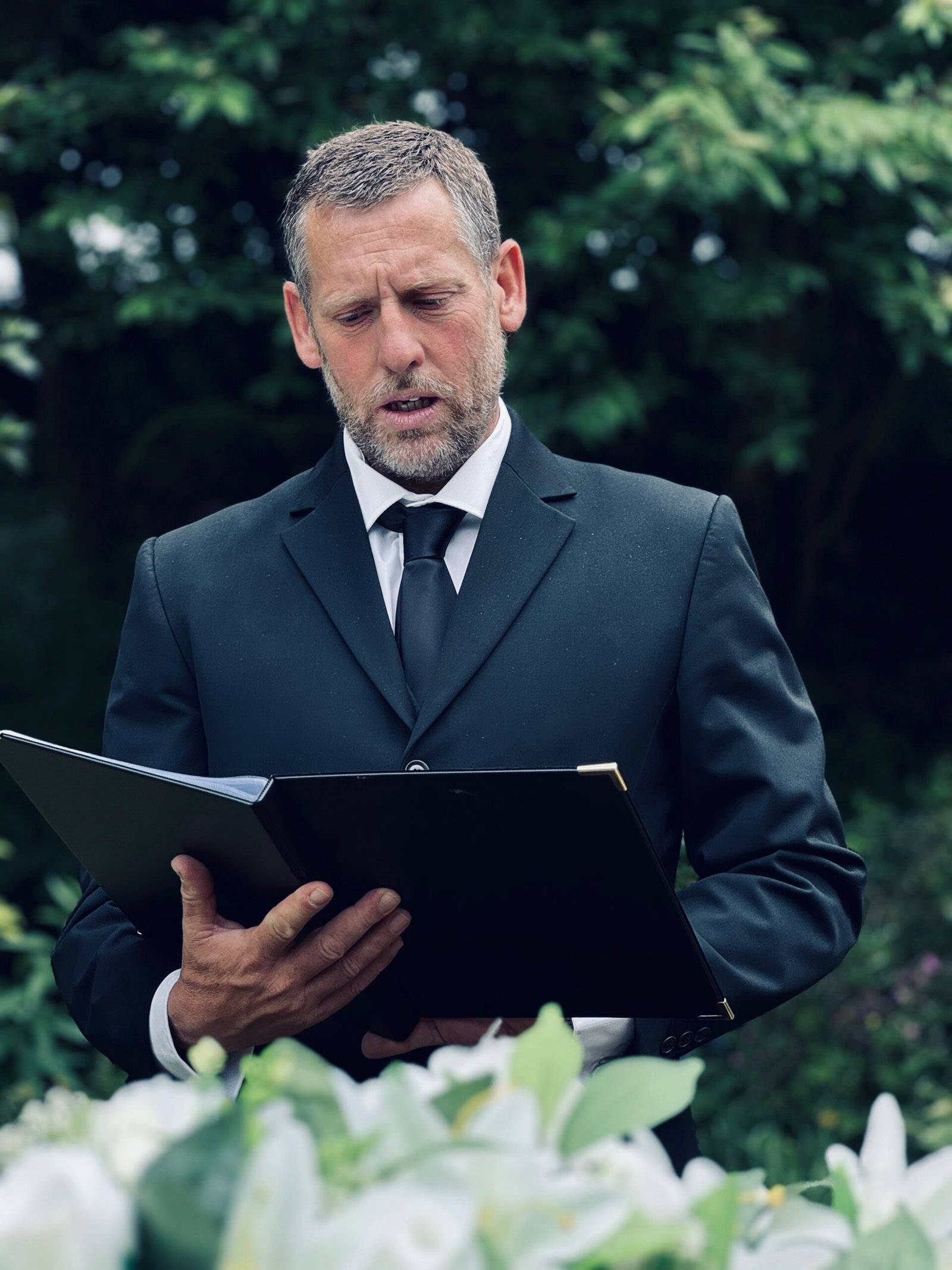 Tim Ruth giving a reading at a funeral