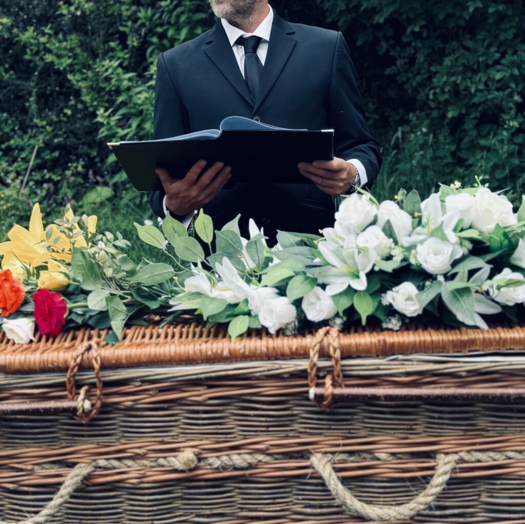 #iamacelebrant photo of Ian H Powell giving reading near wicker coffin